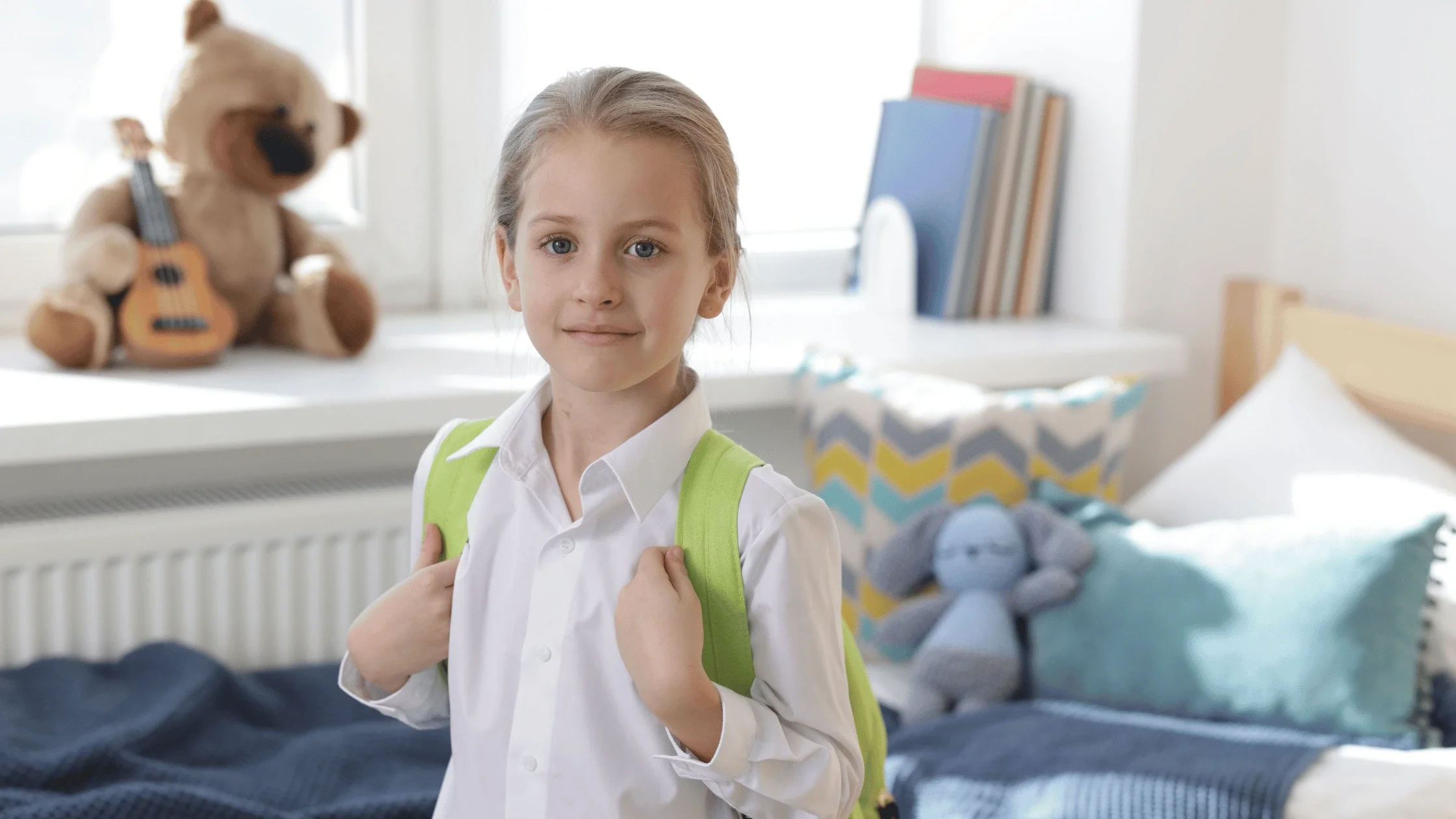 Child wearing a backpack at home while getting ready for the school year